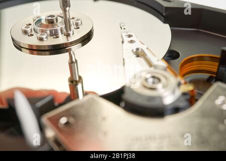 HDD. Inside of hard disk - magnetic disk with a reading head. close-up photo Stock Photo