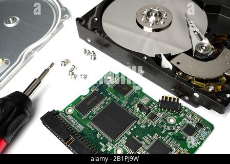 HDD. Inside of hard disk - magnetic disk with a reading head and motherboard. can be used as PC repairing concept Stock Photo