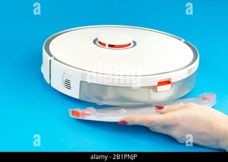 robot vacuum cleaner isolated on blue background. mop replacement .close up photo Stock Photo