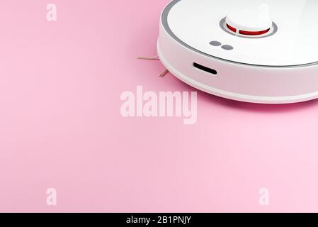 white Robotic vacuum cleaner isolated on pink background Stock Photo