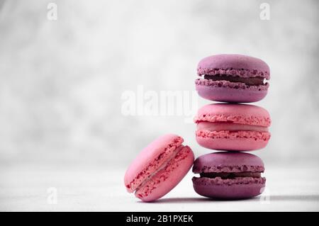 French Pink and Purple Macaroons on Light Grey Background. Stock Photo