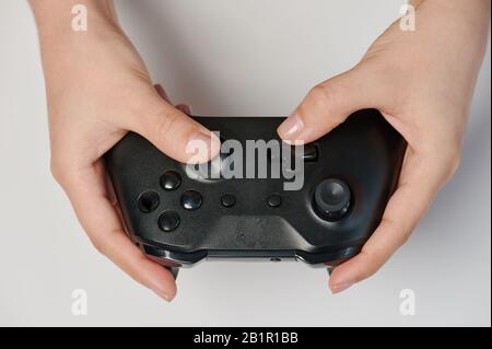 Black game controller in hand close up view isolated Stock Photo