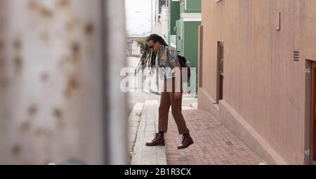 Mixed race man walking in the street Stock Photo