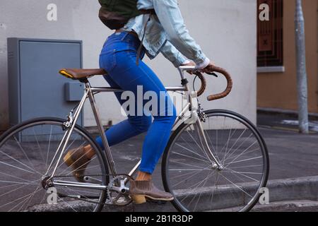 Woman biking in the street Stock Photo