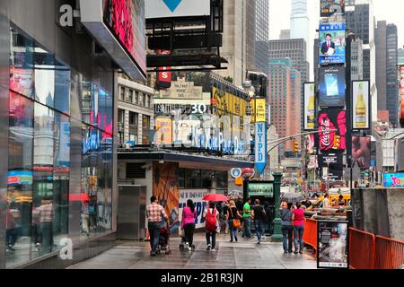 NEW YORK, USA - JULY 1, 2013: People walk by New York Police Department (NYPD) at Times Square in New York. NYPD employs 34,500 uniformed officers. Stock Photo