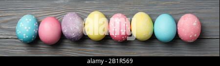 Multicolor Easter eggs on wooden grey background, space for text Stock Photo