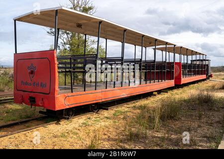 Tavira, Portugal - January 23, 2020: The red mini train at Pedras del Rei station departing for Barril beach at Ilha de Tavira lets visitors forgo the Stock Photo