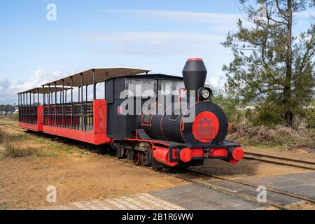 Tavira, Portugal - January 23, 2020: The red mini train at Pedras del Rei station departing for Barril beach at Ilha de Tavira lets visitors forgo the Stock Photo