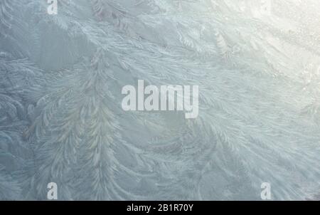 Ice and frost patterns formed on the windscreen of a car Stock Photo