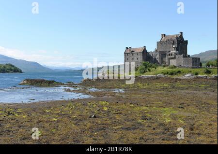The restored castle, Eilean Donan, near Dornie, with Loch Duich at low tide Stock Photo