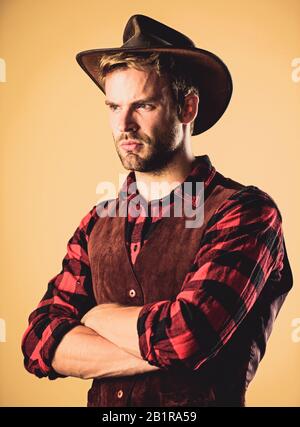 wanted. western cowboy portrait. man checkered shirt on ranch. Vintage style man. Wild West retro cowboy. cowboy in country side. Western. wild west rodeo. Handsome man in hat. Stock Photo