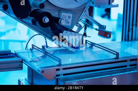 Sticker label printer. Barcode digital printer and applicator machine Stock Photo