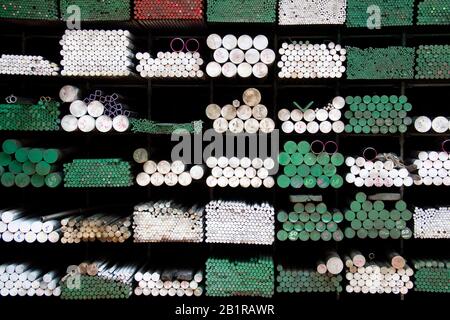 Iron Pipes in different colors, stack in a warehouse in Bangkok, Thailand. Stock Photo