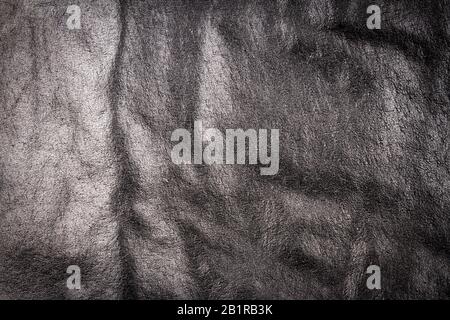 Crumpled black leather texture background. Abstract texture of leather. Stock Photo