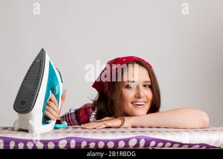 Happy woman ironing loundry isolated over white background Stock Photo