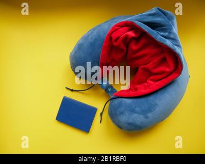 Blue travel pillow isolated on yellow background, top view Stock Photo