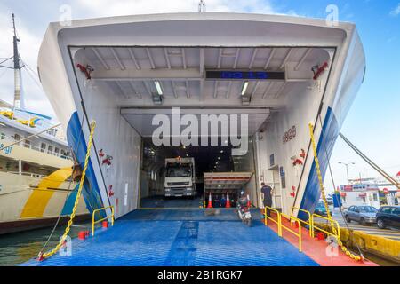 Piraeus, Greece - May 7, 2018: Car-ferry docked in seaport near Athens. Large ship in a sea harbor close-up. Ferryboat loading or unloading by a port Stock Photo