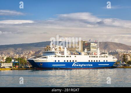 Piraeus, Greece - May 7, 2018: Large car-ferry docked in a seaport near Athens. Panorama of the sea harbor with a ship. Moored ferryboat in the port i Stock Photo