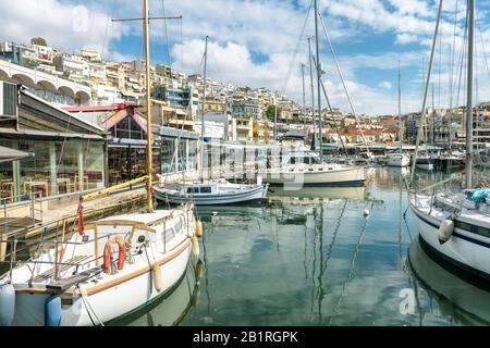 Yachts docked in Mikrolimano in Piraeus, near Athens, Greece. Sailboats parked in a beautiful marina. Panoramic scenic view of the city with sail yach Stock Photo