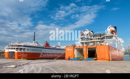 Piraeus, Greece - May 7, 2018: Large car-ferries docked in seaport near Athens. Panoramic view of the ships in sea harbor. Ferryboats loading in a por Stock Photo