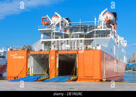 Piraeus, Greece - May 7, 2018: Car-ferry docked in seaport near Athens. Large ship in a sea harbor in summer. Ferryboat loading or unloading by a port Stock Photo