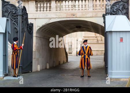 VATICAN - MAY 12: Famous Swiss Guard guarding the entrance to the Vatican City on May 12, 2014 in Vatican. The Papal Guard with about 100 men is the w Stock Photo