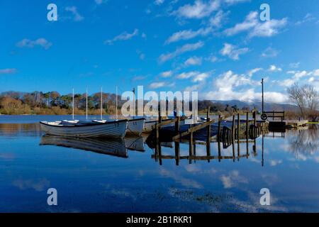 Boats for Hire reflected on mirror calm Loch Leven at the Boat House Loch Leven (Kinross), Scotland. Stock Photo