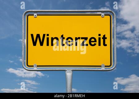 Inscription Winterzeit (wintertime) on a traffic sign, place-name sign Germany, beginning of the town Stock Photo