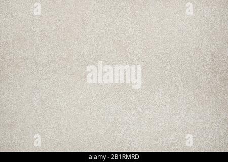 Beige colored  stucco wall, granular structure, pastel background plaster design. House front with white cement. Stock Photo