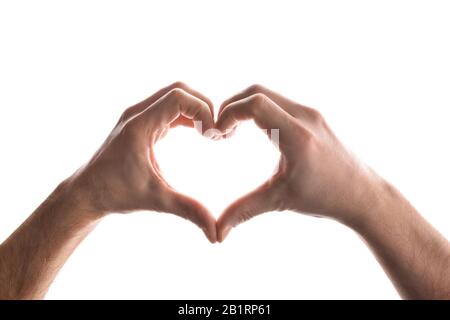 Man hands making the shape of a heart on isolated white background. Horizontal composition. Stock Photo