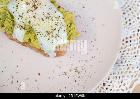 Whole wheat toasted bread with avocado and poached egg Stock Photo