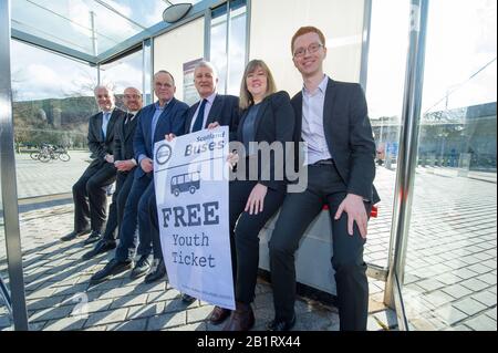 Edinburgh, UK. 27 February 2020. Pictured: L-R) Mark Ruskell MSP; Patrick Harvie MSP; Andy Wightman MSP; John Finnie MSP; Alison Johnstone MSP; Ross Greer MSP. Ahead of the budget debate this afternoon Scottish Greens Parliamentary Co-Leaders Alison Johnstone MSP and Patrick Harvie MSP along with the Green MSP group will stage a photocall outside the Scottish Parliament to celebrate their free bus travel for under 19s budget win. The Scottish Greens yesterday announced that a deal had been struck on free bus travel, more money for councils, extra resource for community safety and an additi Stock Photo