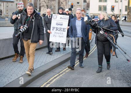 Edinburgh, UK. 27 February 2020. Pictured: (centre) Andy Wightman MSP - Local Government, Communities, Housing & Land Reform and MSP for Lothian for the Scottish Green Party. Ahead of the budget debate this afternoon Scottish Greens Parliamentary Co-Leaders Alison Johnstone MSP and Patrick Harvie MSP along with the Green MSP group will stage a photocall outside the Scottish Parliament to celebrate their free bus travel for under 19s budget win. The Scottish Greens yesterday announced that a deal had been struck on free bus travel, more money for councils, extra resource for community safet Stock Photo