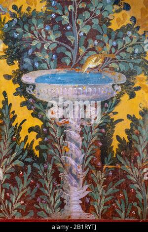 Oplontis Villa of Poppea - On the walls are represented, on a yellow and red background, gardens with beautiful fountains, Stock Photo