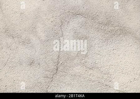 Light gray and rough surface of the wall. Close-up on a plastered wall Stock Photo