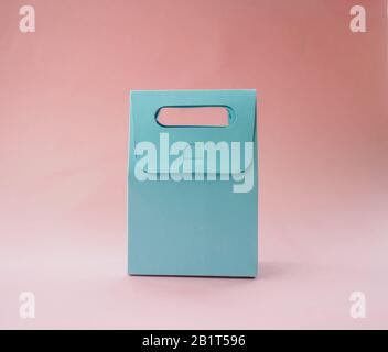paper blue gift bag on pink background. Stock Photo