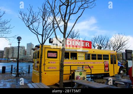 yellow american school bus used as diner in liverpool royal albert dock UK england Stock Photo