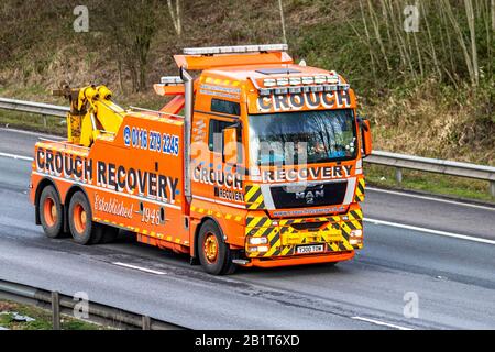 Heavy haulage tow truck towing a National Express coach from Pool