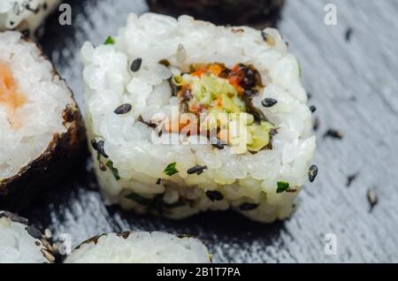 Mix veggie sushi and fish sushi on the black stone plate, japan food Stock Photo