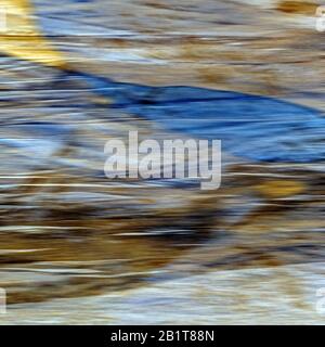 Abstract impressionistic photograph of water and sand patterns on beach at sunset on Cardigan Bay. Stock Photo