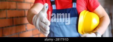 Worker at construction site offering hand to shake Stock Photo