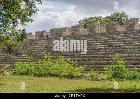 Dzibilchaltun, Yucatan, Mexico: Two women meditating on Structure 44, a 425-foot long platform with a continuous stair. Stock Photo