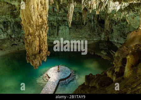 Man enjoying the view of Suytun Cenote from the top Yucatan Mexico North America