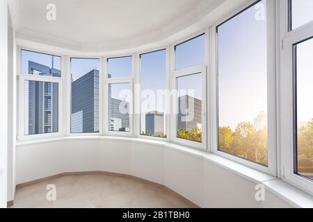 epmty minimalistic interior background, balcony of modern apartment with panoramic windows, city view, nobody, with copy space, vertical Stock Photo