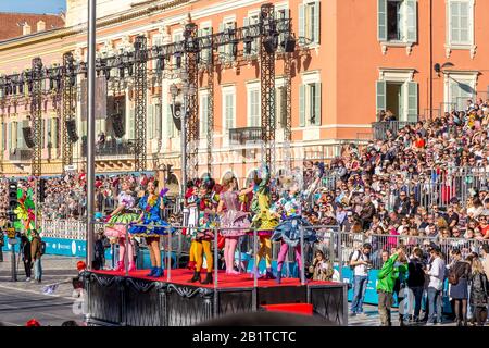 Nice, Cote d’Azur, France - February 15 2020: Carnaval de Nice, This years theme King of Fashion -  Beautiful women waving at on lookers as the flower