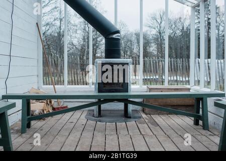 cosy wood burner log fire in a green house in winter Stock Photo