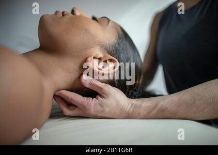 Close up of African American female receiving neck massage Stock Photo