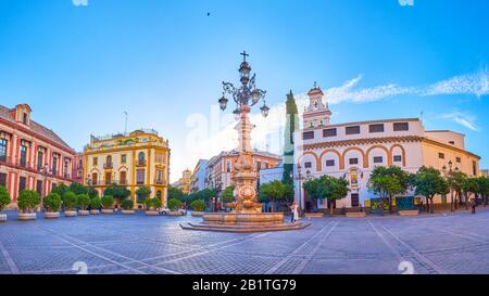 SEVILLE, SPAIN - OCTOBER 1, 2019: Plaza Virgen de los Reyes with its scenic historical streetlight in the middle is the heart of old town, on October Stock Photo