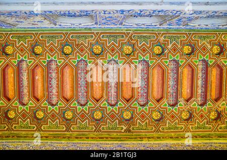 SEVILLE, SPAIN - OCTOBER 1, 2019: The beautiful wooden carved ceilings with colorful geometrical and floral ornaments in Royal Alcazar Palace, on Octo Stock Photo