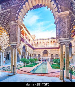 SEVILLE, SPAIN - OCTOBER 1, 2019: The view on magnificent Patio de las Doncellas(Courtyard of the Maidens) with lace-like stone arcades and extended p Stock Photo